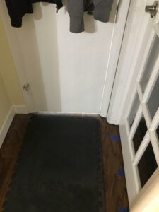 A closed bathroom door with light on. What it might look like on the outside if someone fell and was calling for help.